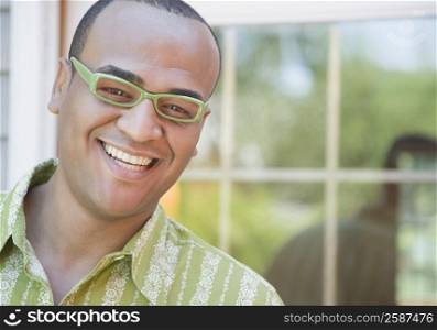 Portrait of a mid adult man wearing eyeglasses and smiling