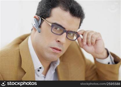 Portrait of a mid adult man wearing hands free device