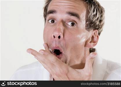 Portrait of a mid adult man wiping his mouth