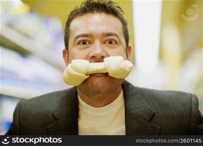 Portrait of a mid adult man with a dog bone in his mouth
