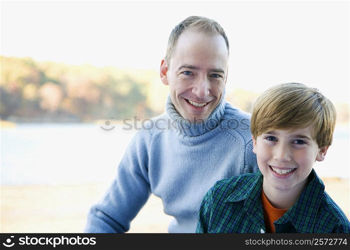Portrait of a mid adult man with his son smiling