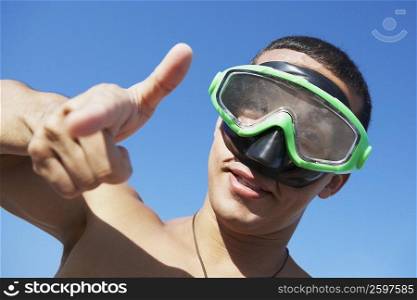 Portrait of a mid adult man with swimming goggles gesturing