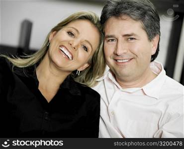 Portrait of a mid adult woman and a mature man smiling
