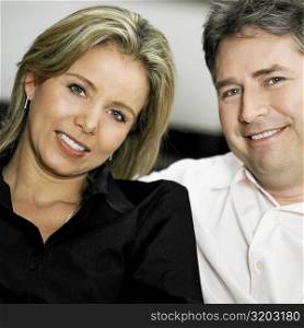 Portrait of a mid adult woman and a mature man smiling