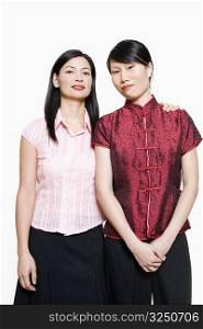 Portrait of a mid adult woman and young woman standing side by side