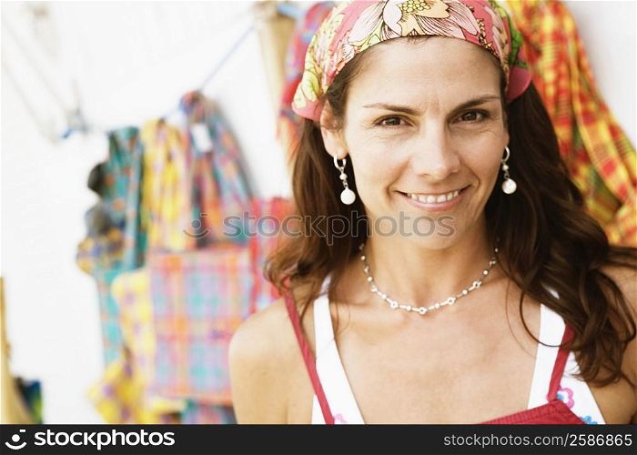 Portrait of a mid adult woman at a market stall and smiling