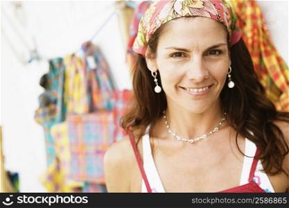 Portrait of a mid adult woman at a market stall and smiling