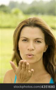Portrait of a mid adult woman blowing a kiss