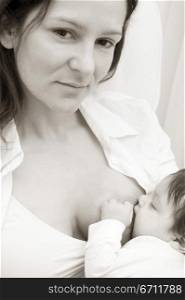 Portrait of a mid adult woman breastfeeding her baby