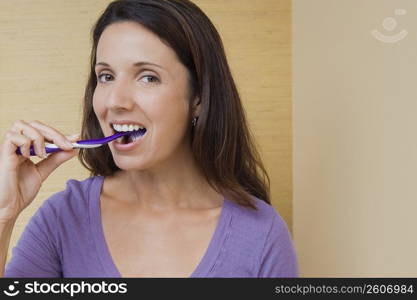 Portrait of a mid adult woman brushing her teeth