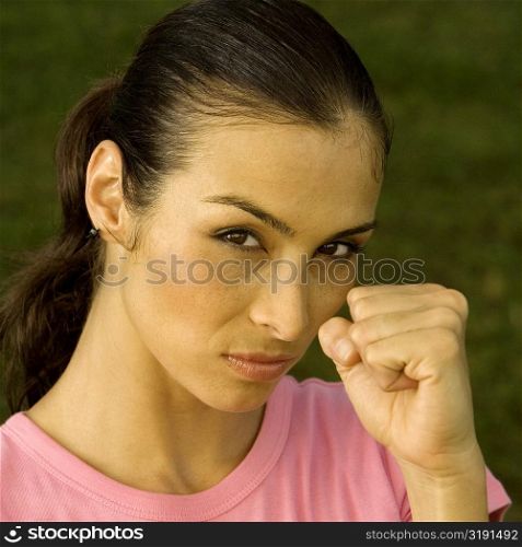 Portrait of a mid adult woman clenching her fist