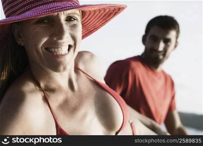 Portrait of a mid adult woman clenching her teeth with a mid adult man sitting beside her