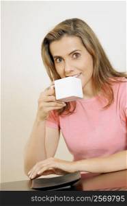 Portrait of a mid adult woman drinking a cup of coffee