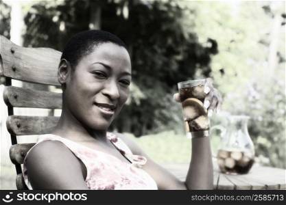 Portrait of a mid adult woman drinking ice and smiling