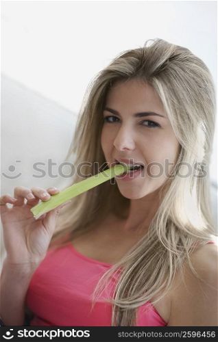 Portrait of a mid adult woman eating celery