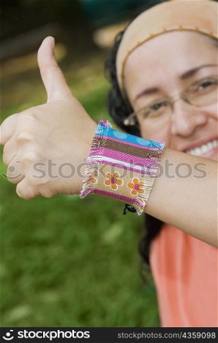 Portrait of a mid adult woman giving a thumbs up sign