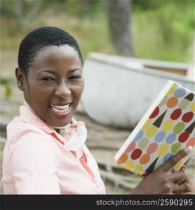 Portrait of a mid adult woman holding a book and smiling