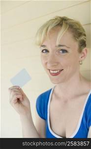 Portrait of a mid adult woman holding a credit card and smiling