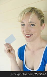 Portrait of a mid adult woman holding a credit card and smiling