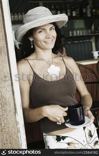 Portrait of a mid adult woman holding a cup of coffee