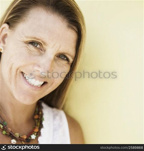 Portrait of a mid adult woman holding a digital camera and smiling