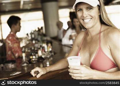 Portrait of a mid adult woman holding a drink