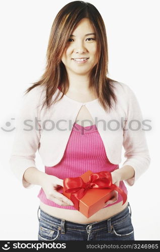 Portrait of a mid adult woman holding a gift
