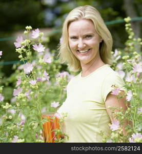 Portrait of a mid adult woman holding a glass of juice and smiling