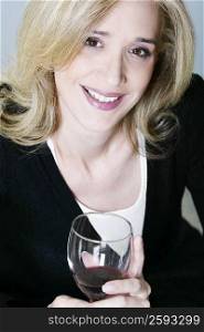 Portrait of a mid adult woman holding a glass of wine
