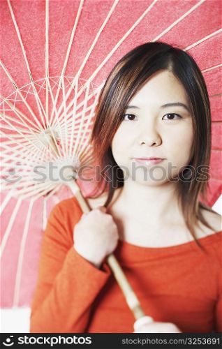 Portrait of a mid adult woman holding a parasol