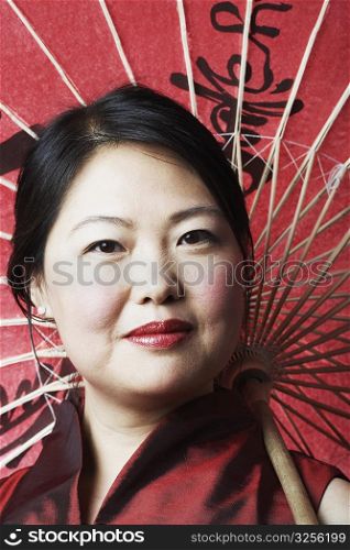 Portrait of a mid adult woman holding a parasol