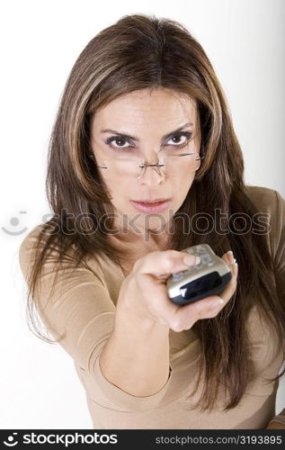 Portrait of a mid adult woman holding a remote control