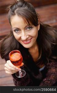 Portrait of a mid adult woman holding a wine glass and smiling