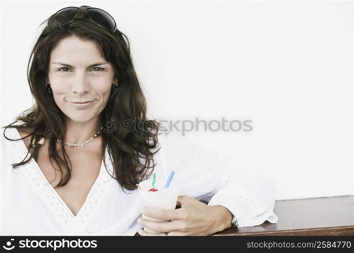 Portrait of a mid adult woman holding an ice-cream cup