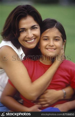 Portrait of a mid adult woman hugging her daughter