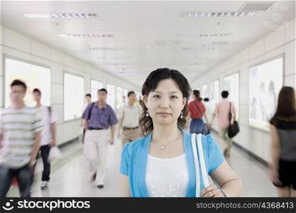 Portrait of a mid adult woman in a corridor