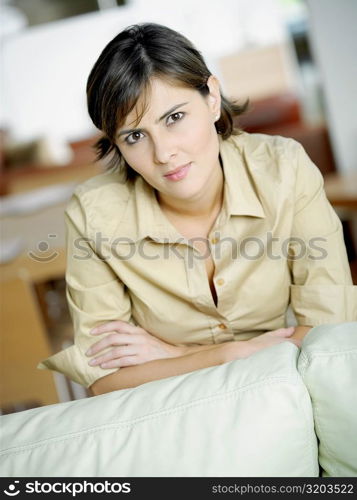 Portrait of a mid adult woman leaning over a couch