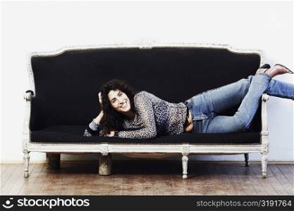Portrait of a mid adult woman lying on a couch