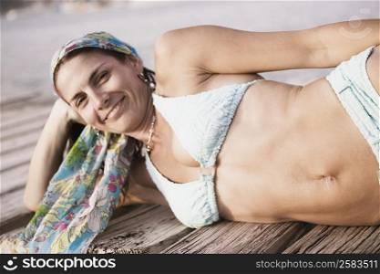 Portrait of a mid adult woman lying on a pier