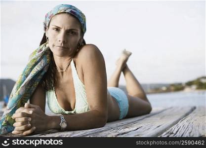 Portrait of a mid adult woman lying on a pier