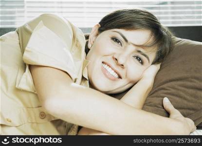 Portrait of a mid adult woman lying on her side and smiling