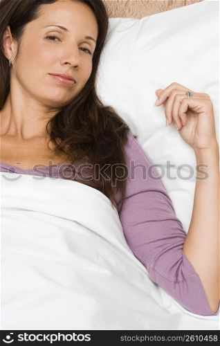 Portrait of a mid adult woman lying on the bed