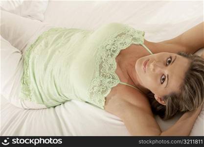 Portrait of a mid adult woman lying on the bed