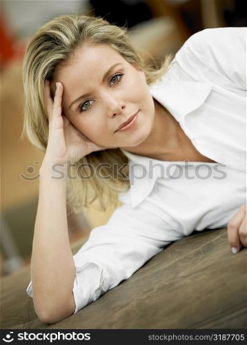 Portrait of a mid adult woman lying on the bed and thinking