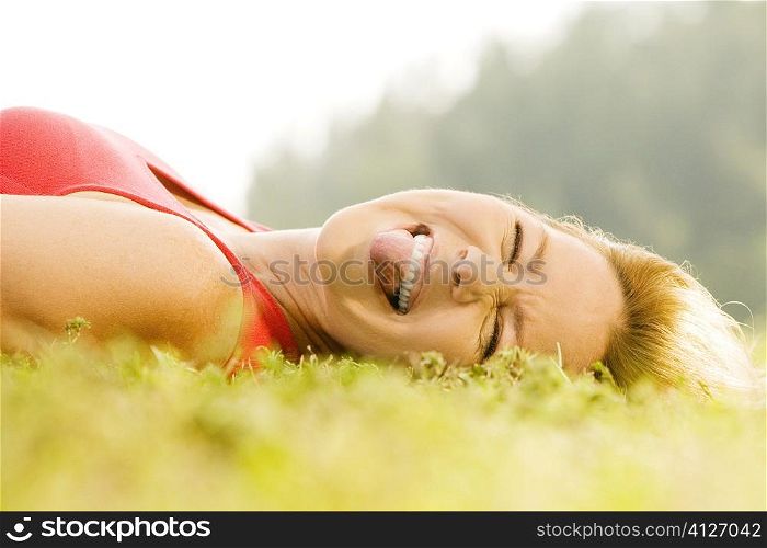 Portrait of a mid adult woman lying on the grass