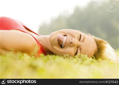 Portrait of a mid adult woman lying on the grass