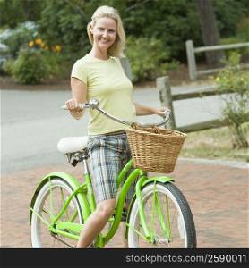 Portrait of a mid adult woman on a bicycle and smiling