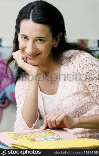 Portrait of a mid adult woman reading a book and smiling