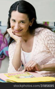 Portrait of a mid adult woman reading a book and smiling