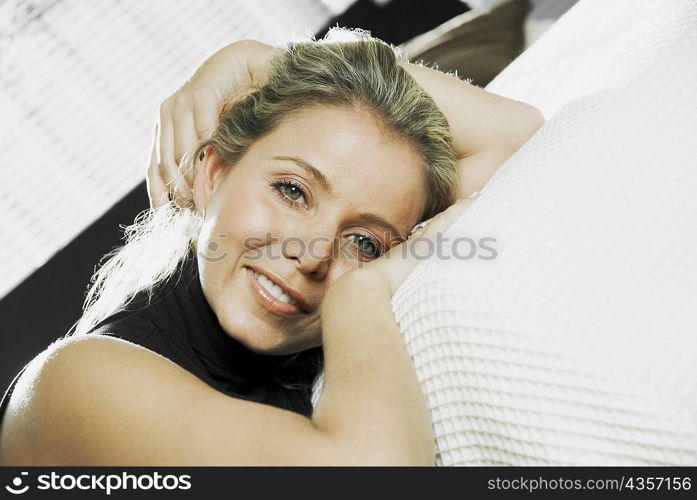 Portrait of a mid adult woman reclining on the bed